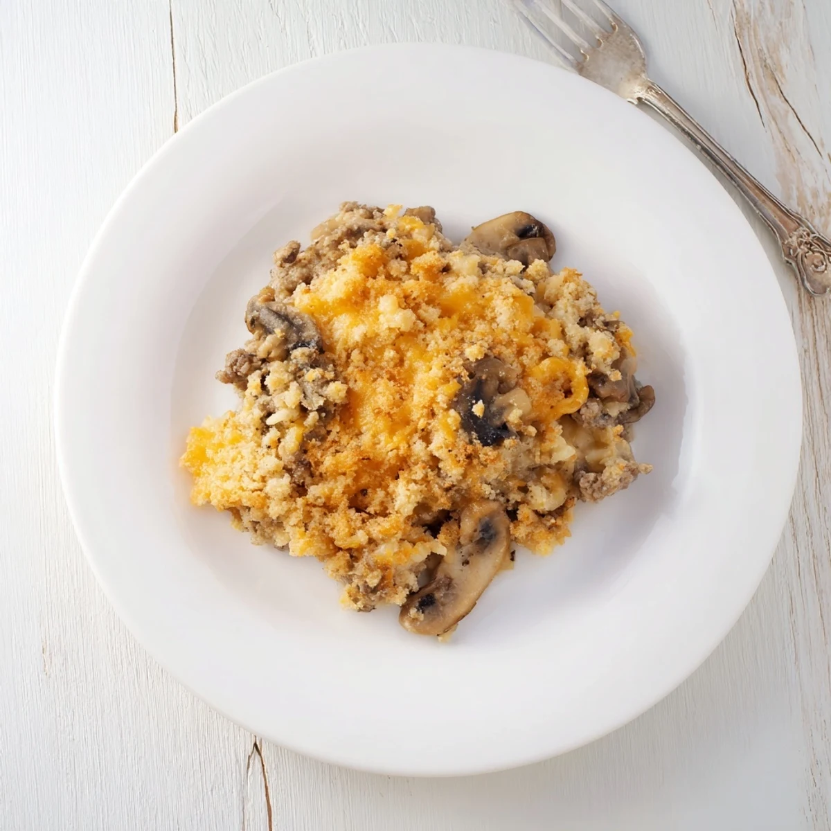 Hearty hamburger mushroom bake featuring savory beef mushrooms and gooey cheese layer with a golden crunchy topping