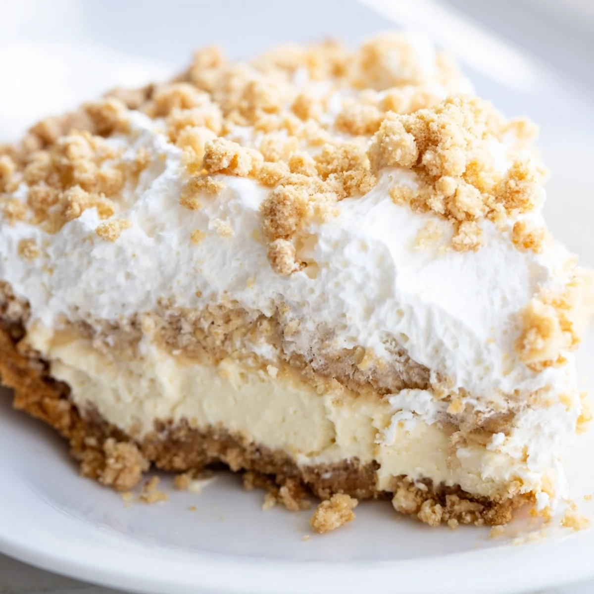 Creamy Old Fashioned Amish Peanut Butter Dream Pie topped with fluffy whipped cream and golden crumbs
