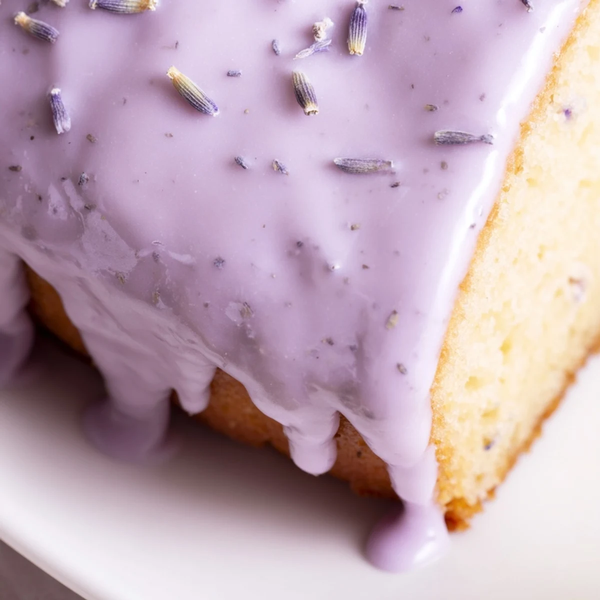Purple-hued lavender glaze dripping down golden scones fresh from the oven