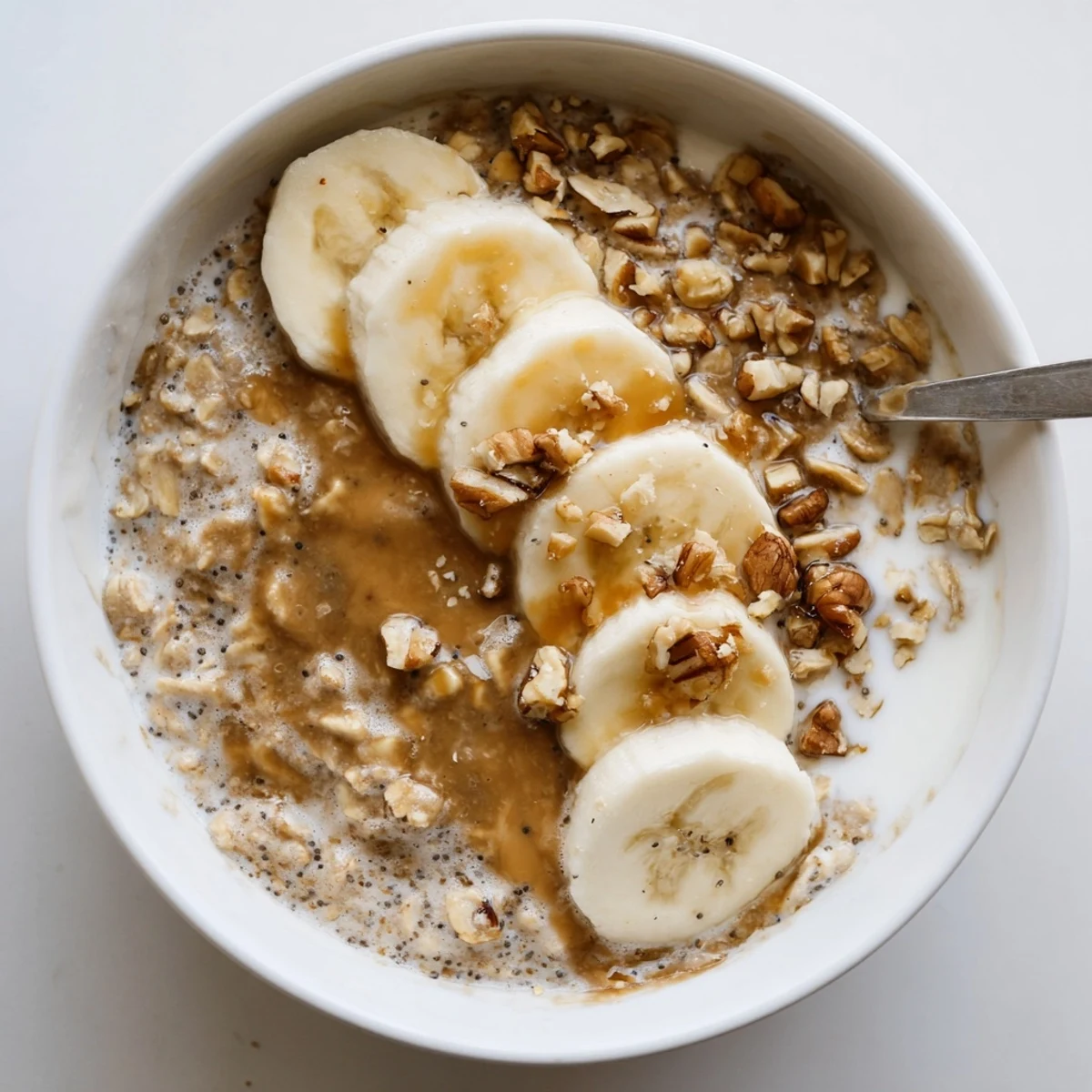 Make-ahead Brown Sugar Coffee Overnight Oats garnished with maple drizzle and crunch.