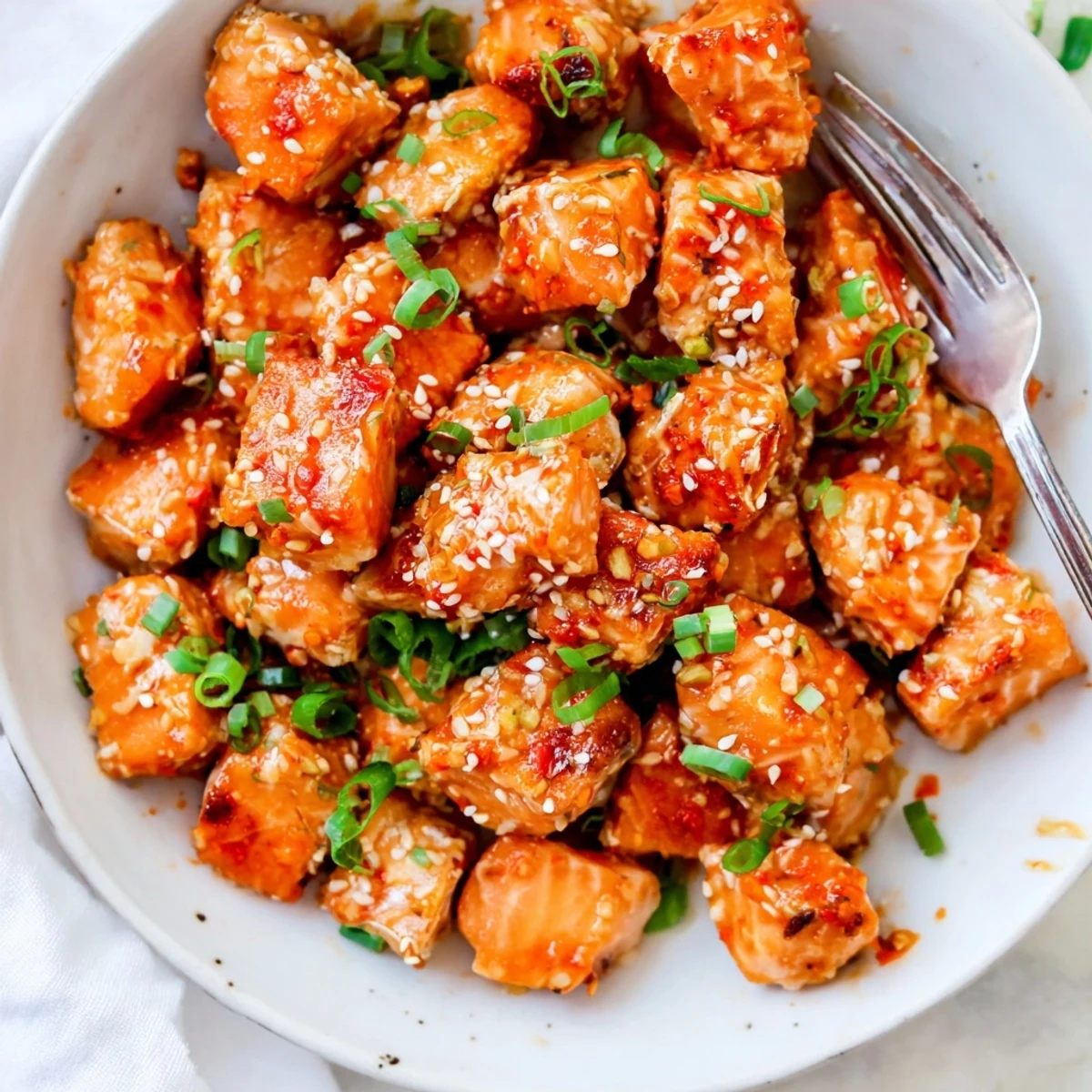 Bang Bang Salmon Bites Recipe: crispy golden salmon cubes tossed in creamy sauce