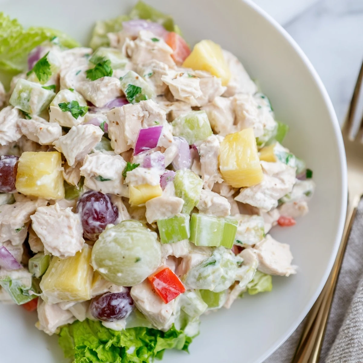 Bright Hawaiian Chicken Salad Recipe served on butter lettuce, garnished with cilantro.
