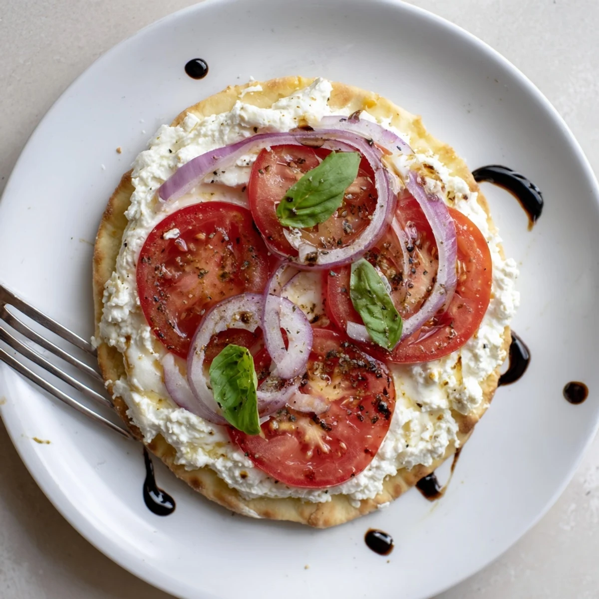 Warm Caprese Pita Pizza With Whipped Garlic Feta, melty mozzarella and basil  