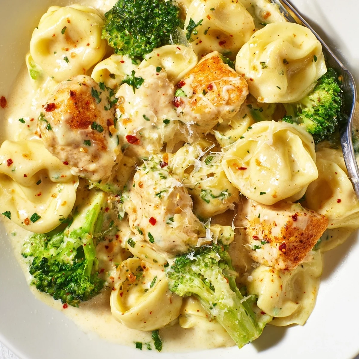 Creamy Garlic Parmesan Tortellini Chicken Broccoli Recipe served hot with crusty bread for dipping