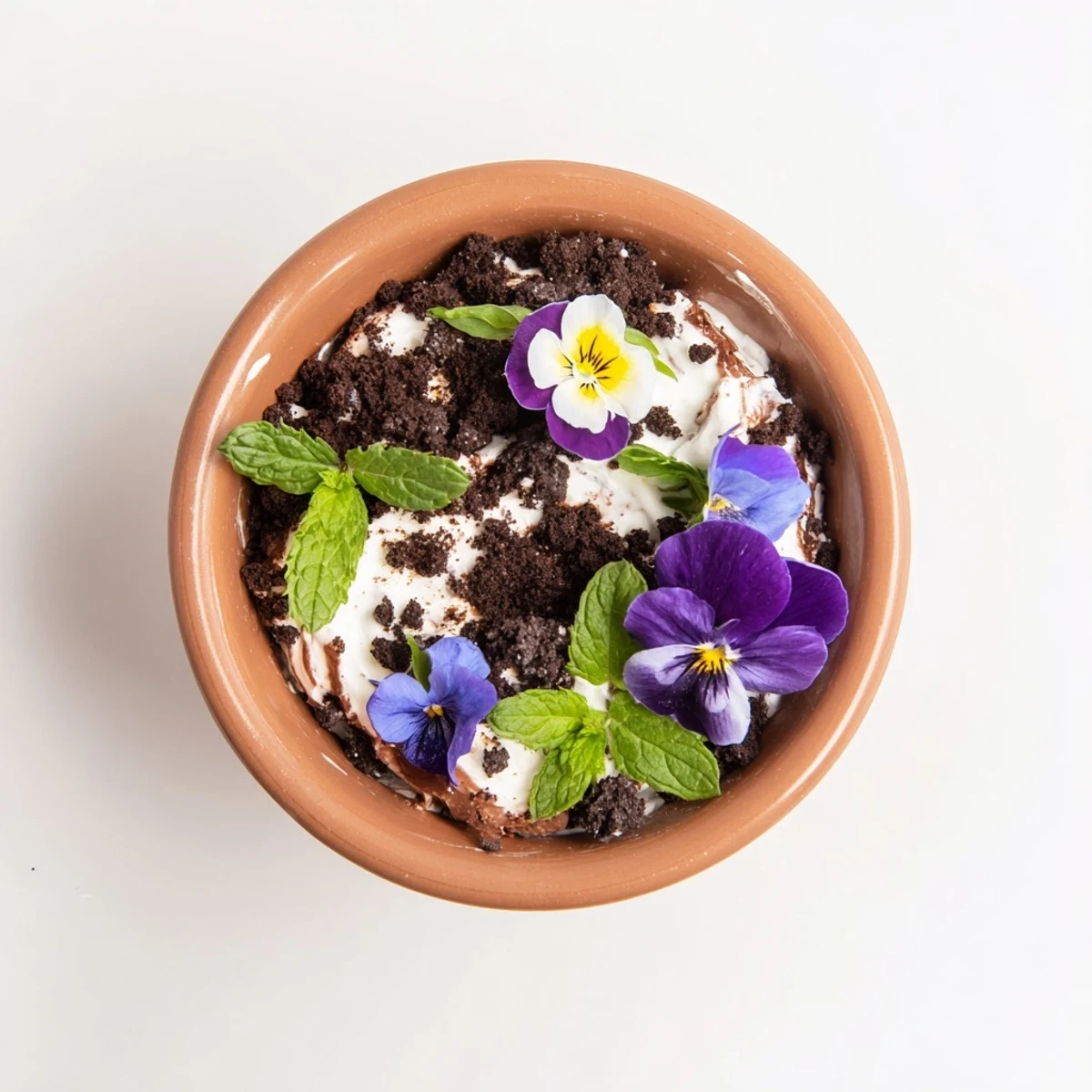 Whimsical edible potted floral garden dessert with chocolate cake layers and vibrant flowers