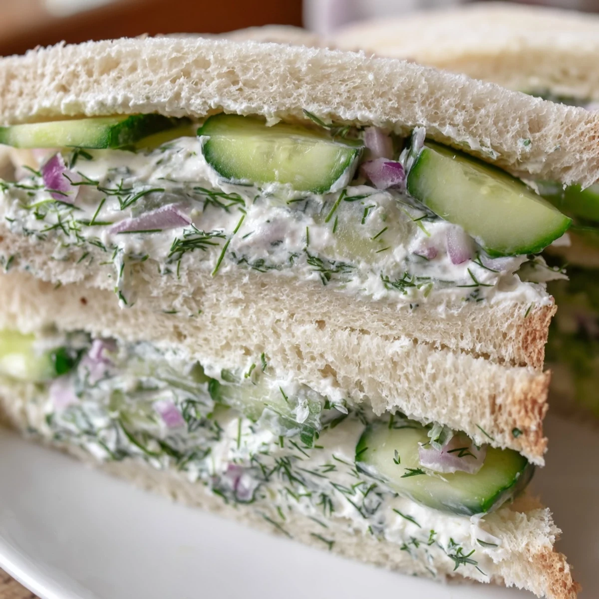 Fresh cucumber salad sandwiches arranged on a plate with crisp green cucumber slices