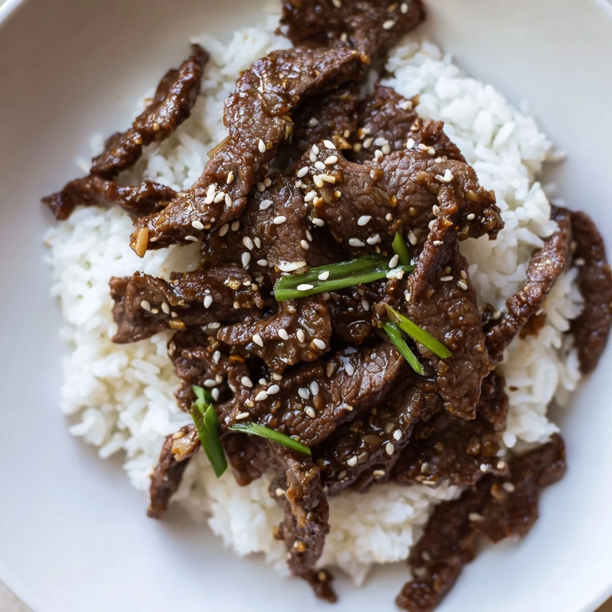 Bowl of Korean Beef topped with scallions and toasted sesame seeds