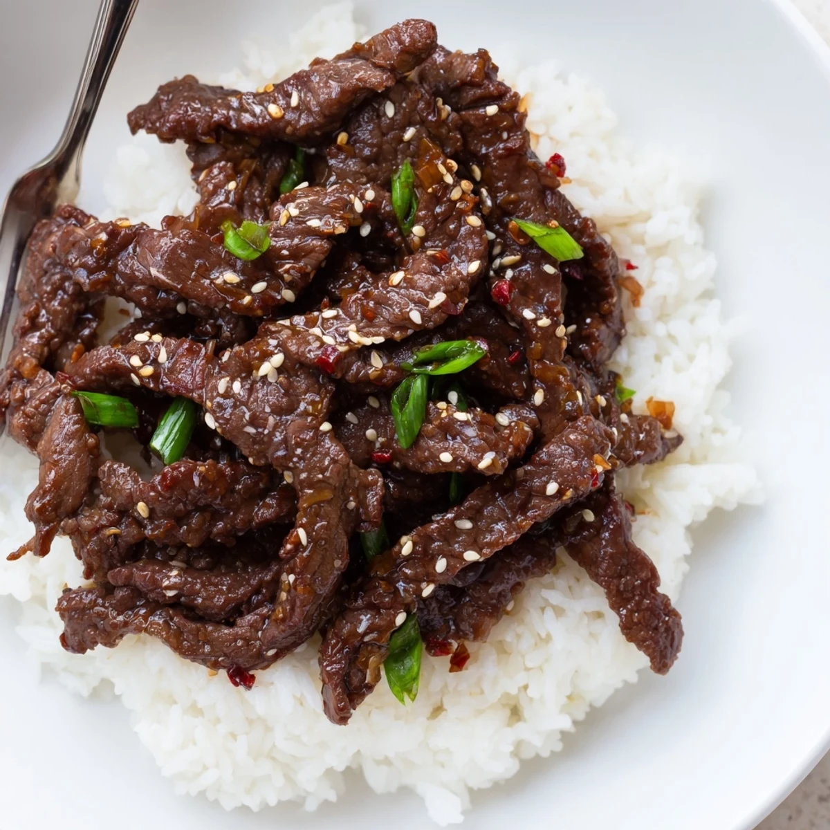 Thinly sliced Korean Beef glistening with sweet-savory sauce, steam rising