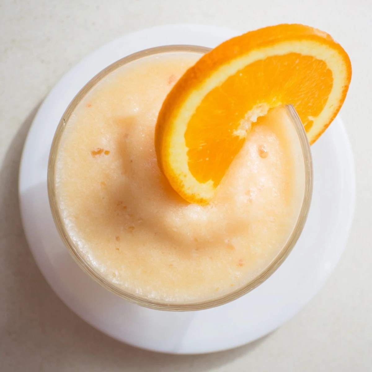 Frosty orange cream slush displaying swirls of vanilla ice cream and fresh citrus pulp