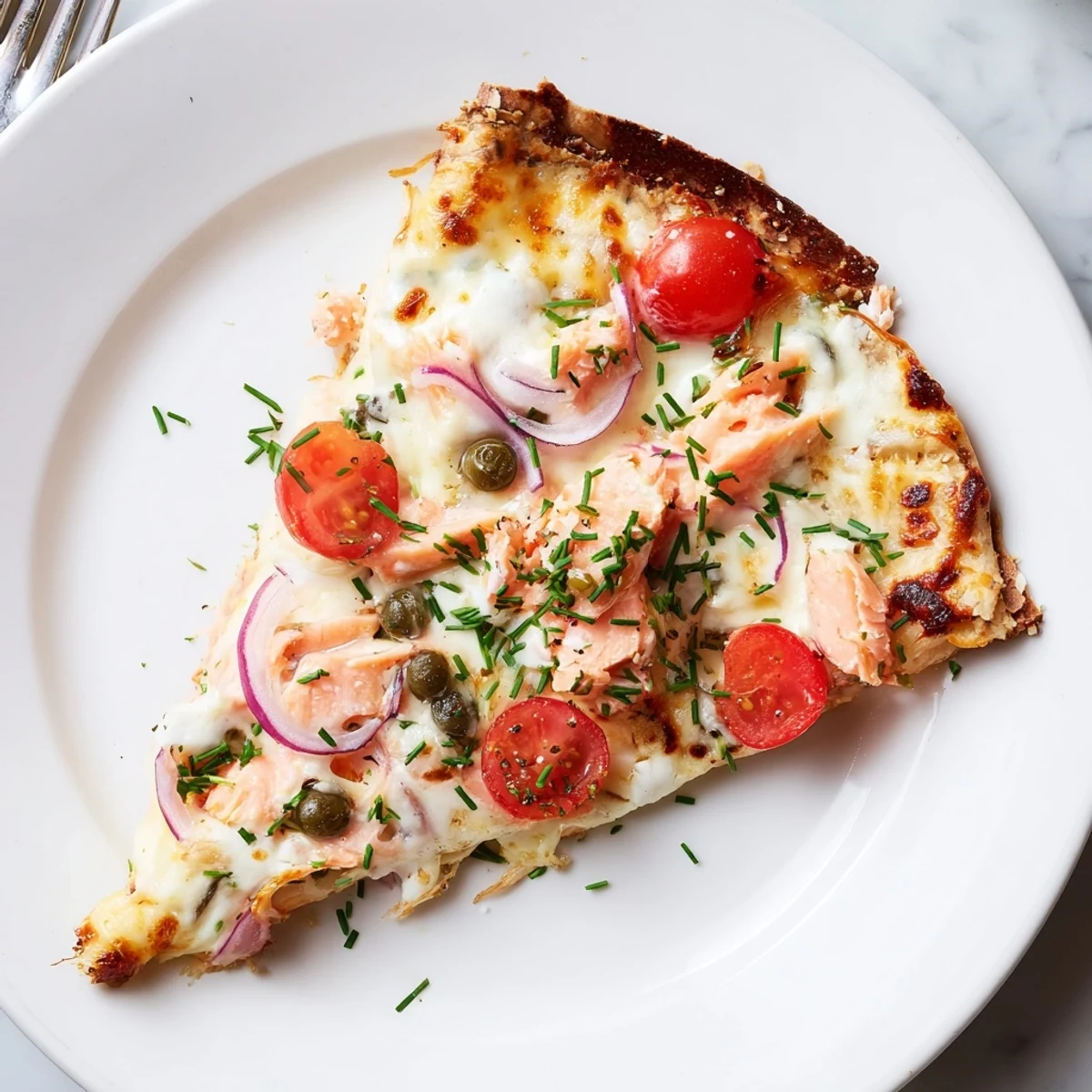 A quick leftover salmon tortilla pizza recipe featuring a crisp tortilla base and savory herb cream sauce.