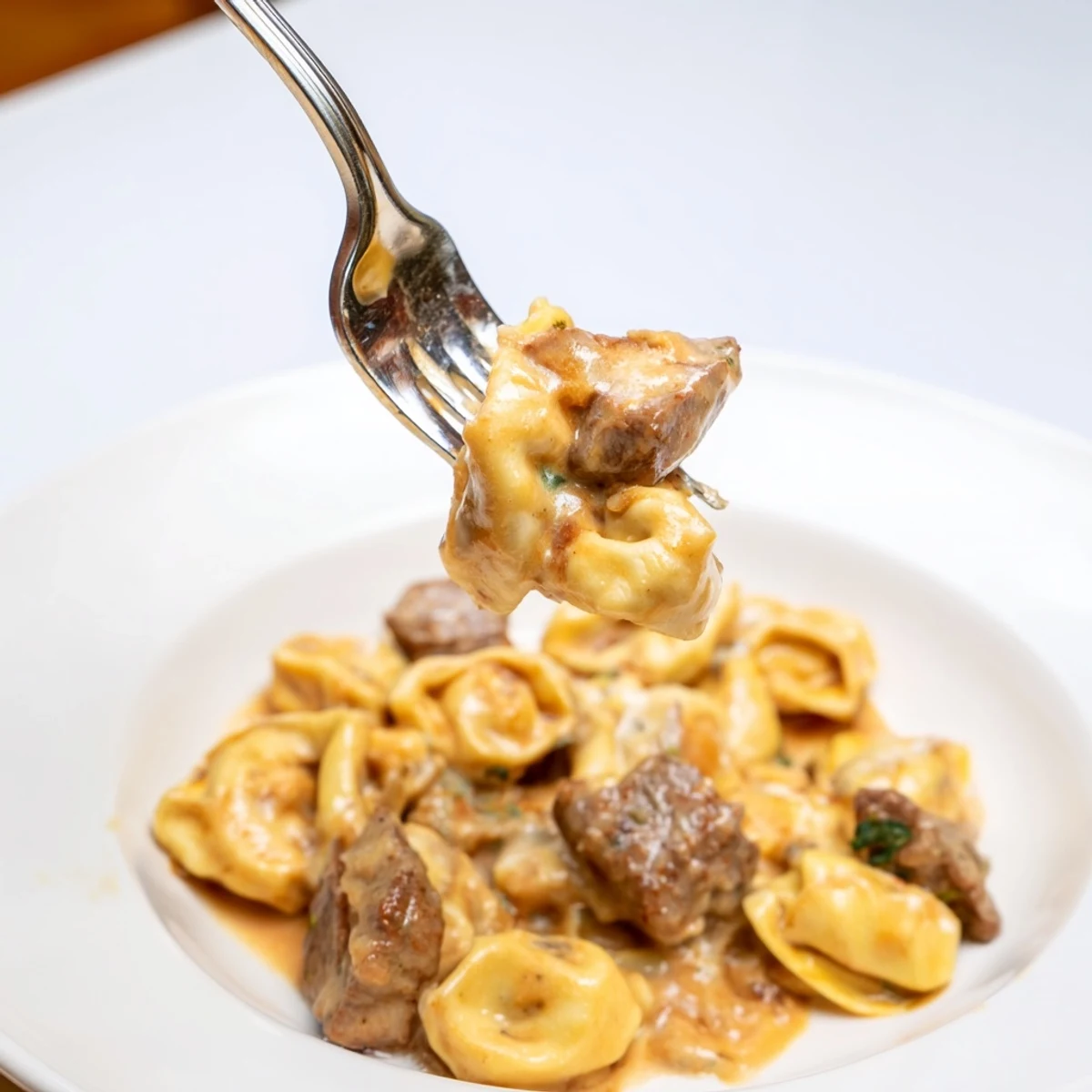Creamy garlic steak tortellini featuring browned sirloin bites tossed in rich parmesan sauce